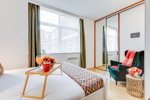 Studio rental on Airbnb in Prague with bed chair and closet with window