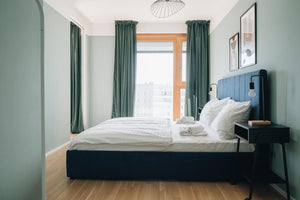 Spacious bedroom of rental apartment close to Vienna train station digital nomads working