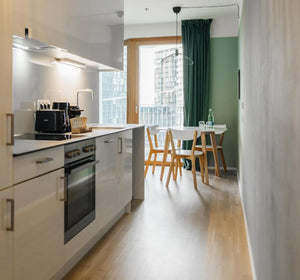 Spacious kitchen and dining area of rental apartment close to Vienna train station digital nomads working