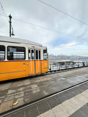 Yellow Tram streetcar going past Danube River in Budapest Hungary
