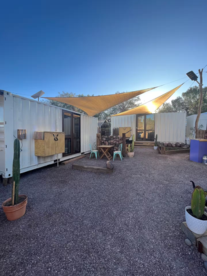 Digital nomads travelling through Atacama Desert, Chile. Couple travel, slow travel, working remotely, vegan travel, budget travel. Affordable accommodation in shipping container near Valle de la luna (Valley of the Moon) and Laguna Baltinache near San Pedro de Atacama, Chile. On Airbnb.
