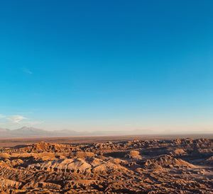 Digital nomads travelling through Atacama Desert, Chile. Couple travel, slow travel, working remotely, vegan travel, budget travel. Valle de la luna (Valley of the Moon) near San Pedro de Atacama, Chile.