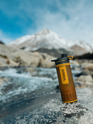 Digital nomads travelling through Patagonia. Couple travel, slow travel, working remotely, vegan travel, budget travel. Water purification water bottle drinking glacier water. Grayl waterbottle. Mont Fitz Roy near El Chalten, Argentina.