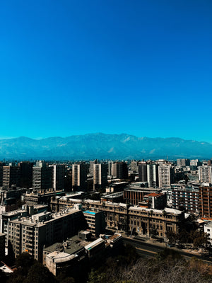 Digital nomads travelling through Chile. Couple travel, slow travel, working remotely, vegan travel, budget travel. Vista of Andes and Santiago skyline.