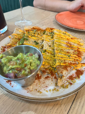 Digital nomads living in Santiago eating vegan plant-based food at Sapiens restaurant enjoying a Quesadilla