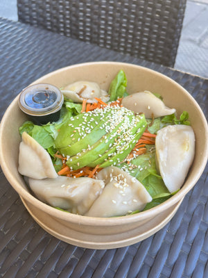 Digital nomads living in Santiago eating vegan plant-based food at SweetFran restaurant enjoying a dumplings avocado and fresh salad