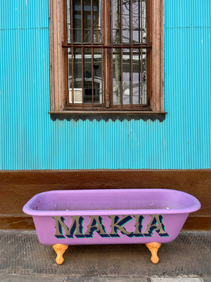 Digital nomads travelling through Valparaiso, Chile. Couple travel, slow travel, working remotely, vegan travel, budget travel. Street art bathtub.