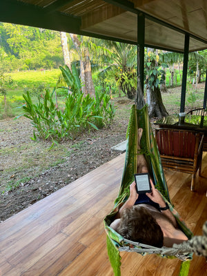 Digital nomads in Drake Bay Costa Rica reading in hammock working remotely in jungle forest