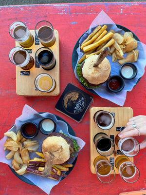 Digital nomads at Monteverde Brewing Company enjoying a vegan plant-based burger and beers after day of remote work and hiking