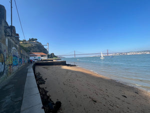 Ponto Final Restaurant from Netflix's Somebody Feed Phil seen in Lisbon Portugal with Lisbon suspension bridge in background