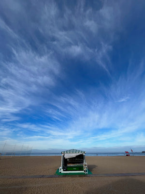 Portugal Nazare local vendor on the beach. Cute and picturesque walk during our slow travel digital nomad budget stay.