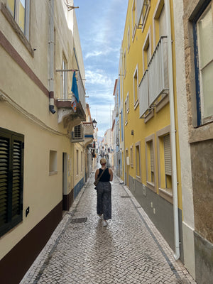 Portugal Nazare lane and alley way cobblestone streets. Cute and picturesque walk during our slow travel digital nomad budget stay.