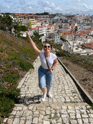 Portugal Nazare climbing up the path to Praia do Norte during our slow travel digital nomad budget stay.