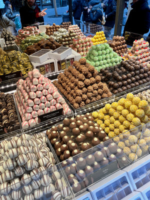 Digital nomads travelling through Prague. Couple travel, slow travel, working remotely, vegan travel, and budget travel. Marzipan assortment offered at Prague Christmas Markets.
