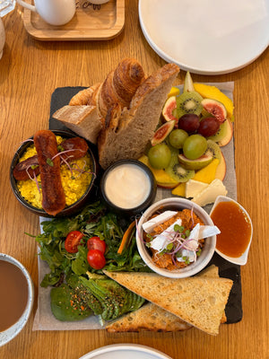 Tofu scramble, fruit, toast, avocado, vegan sausage, full vegan and plant-based breakfast.