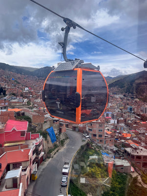 Orange line of the La Paz Teleferico network going over the city in Bolivia