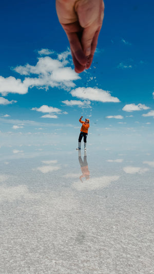 Digital nomads travelling through the Salt Flats in Bolivia near Uyuni. Couple travel, slow travel, working remotely, vegan travel, budget travel. Posing on the Salt Flats.