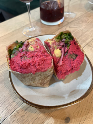 Digital nomads living in Santiago eating vegan plant-based food at Sapiens restaurant enjoying a beet hummus tofu chickpea wrap