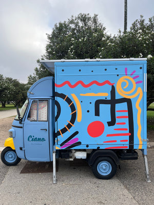Tiny coffee truck painted bright blue in Lisbon Portugal