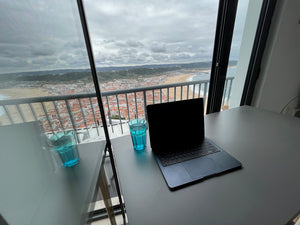 Beautiful view of ocean and beach from Airbnb in Nazare Portugal with laptop working remotely