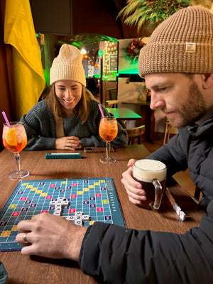 Playing scrabble with beers and aperol spritz in Prague during Christmas Markets